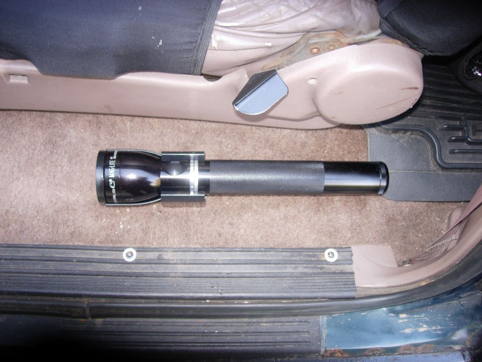 Maglite flashlight on vehicle floor
