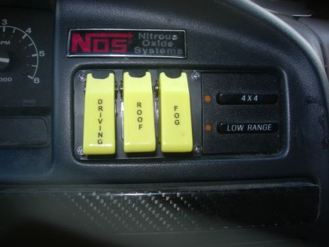 1993 Ford Bronco - Interior view of a vehicle's dashboard, showing aftermarket switches for driving, roof, fog lights, 4x4, and low range.