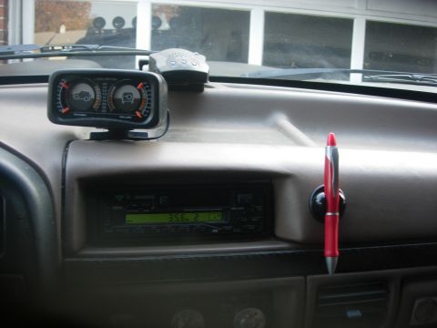 1993 Ford Bronco - Interior view of a vehicle's dashboard with aftermarket gauge and radio.