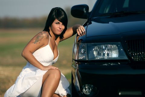 2003 Mercury Marauder - A woman poses next to a black 2003 Mercury Marauder.