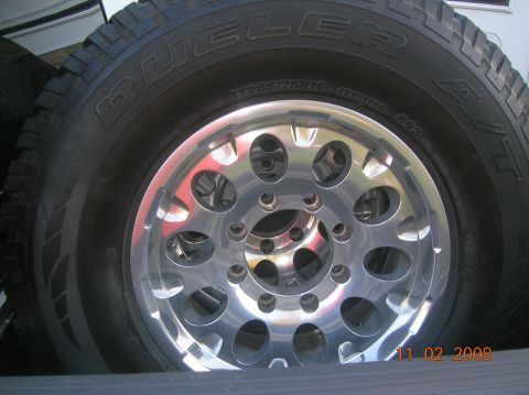 1985 Ford Bronco - A close-up view of a tire and wheel assembly, with visible tire brand and model information.