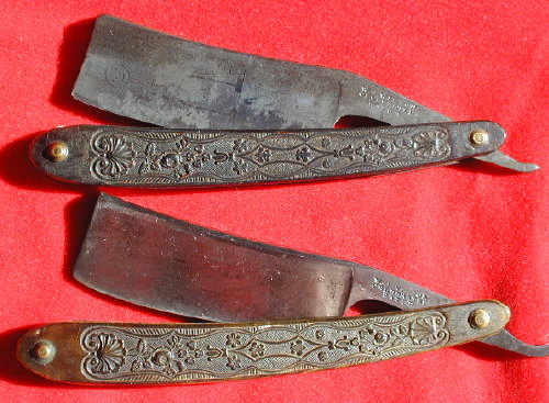 Two antique straight razors with ornate handles