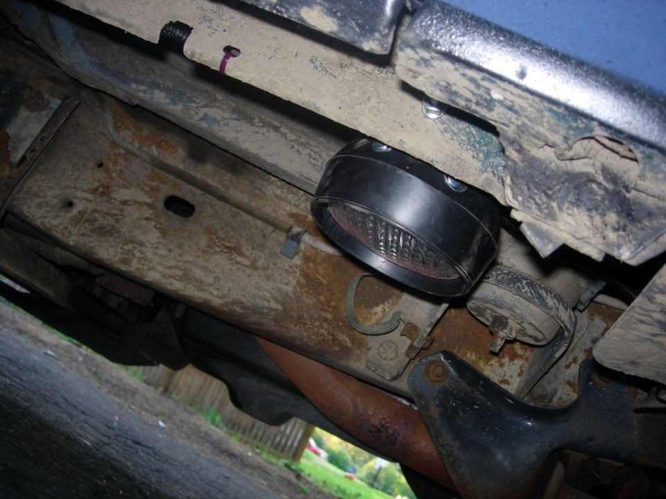 Underside of a 1993 Ford Bronco with a black light mounted to the frame.
