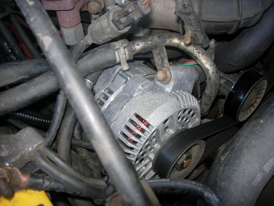 Serpentine belt and alternator on a 1993 Ford Bronco engine.