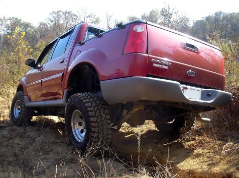 2002 Ford Sport Trac - Modified 2002 Ford Sport Trac with off-road tires navigates a rough trail.