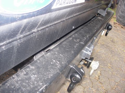 1993 Ford Bronco - Close-up of a vehicle's rear bumper and tow hitch assembly, with partial text visible on an upper plate.