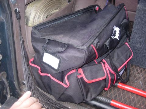1993 Ford Bronco - Interior view of tool bags and a strap stored in a vehicle.