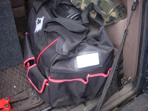 1993 Ford Bronco - A tool bag and bolt cutters are visible inside the cargo area of a vehicle.
