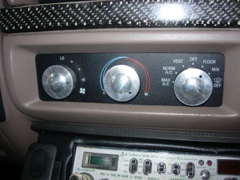 1993 Ford Bronco - Climate controls and CB radio visible in the interior of a vehicle.