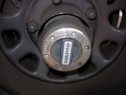 1993 Ford Bronco - This photo shows a Warn manual locking hub, a part of a vehicle's drivetrain.