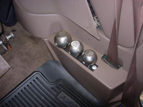 1993 Ford Bronco - Three metal balls are stored in a compartment inside the vehicle's interior.