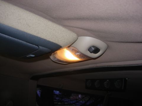 1993 Ford Bronco - Close-up of the interior dome light and overhead console in a vehicle.