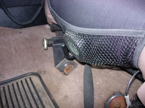 1993 Ford Bronco - Interior shot focusing on a seat adjustment mechanism and a mesh seat cover.