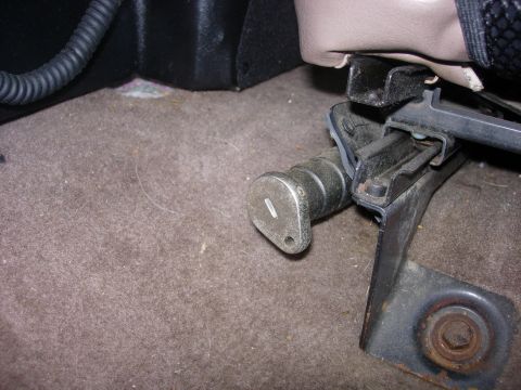 1993 Ford Bronco - The image shows a close-up of a seat adjustment lever mechanism inside a vehicle.