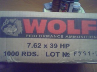 1990 Ford Bronco - A box of Wolf Performance Ammunition is shown with lot details and a SuperMotors logo.