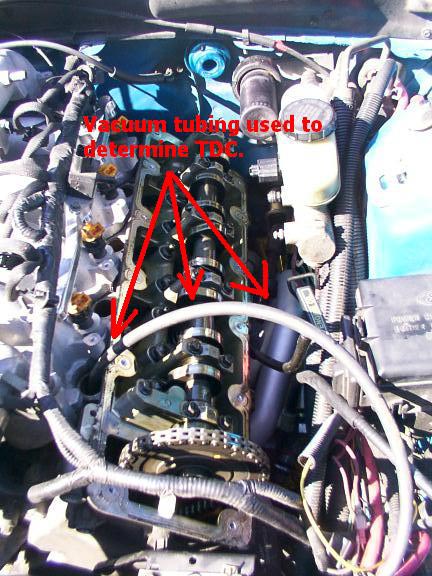 2007 Ford Mustang - Close-up view of an engine bay, highlighting the camshaft, timing chain, and vacuum tubing used for TDC determination.
