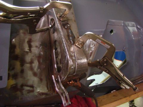 1948 Jeep Wrangler - Clamps holding a metal automotive body panel during repair work.