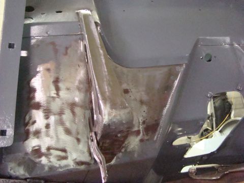 1948 Jeep Wrangler - This photo shows the undercarriage of a vehicle undergoing repair, with visible metalwork and primer applied to the floor pan.