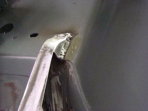 1948 Jeep Wrangler - Close-up of interior bodywork, showing metal bracing and a hose attached to a panel.
