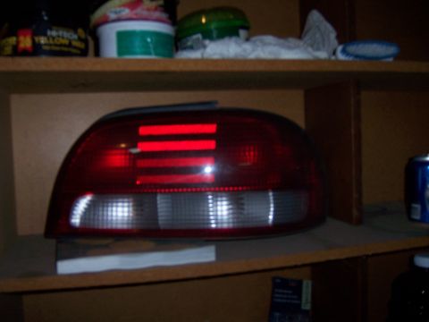 1991 Ford Bronco - A red taillight assembly is displayed on a shelf, likely a replacement part.
