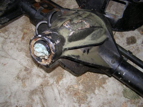 1993 Ford Bronco - Close-up view of a vehicle's differential housing with the seal removed and stuffing visible within the opening.