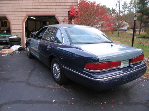 1991 Ford LTD Crown Victoria - This 1991 Ford Crown Victoria LTD features a distinctive two-tone blue paint scheme and is parked in a driveway.