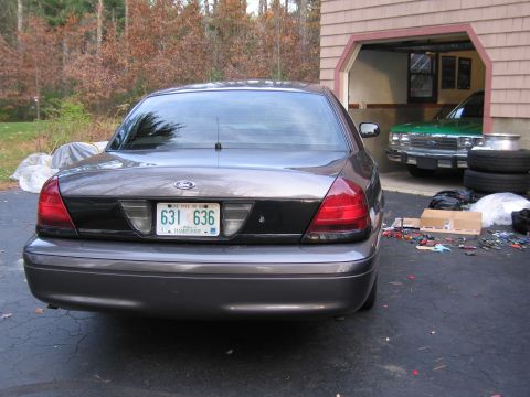 1991 Ford LTD Crown Victoria - Gray Ford Crown Victoria parked outside a garage, with a green vehicle inside.