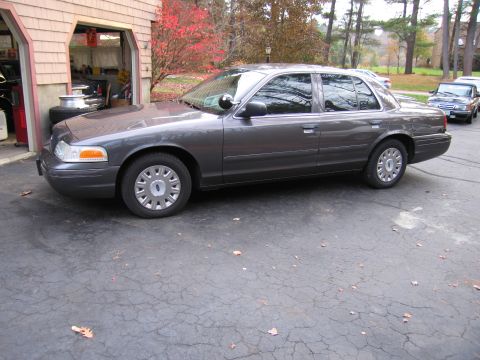 1991 Ford LTD Crown Victoria - Side view of a gray Ford Crown Victoria parked in a driveway.