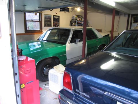 1991 Ford LTD Crown Victoria - Two sedans, one a 1991 Ford Crown Victoria LTD, are parked inside a garage.