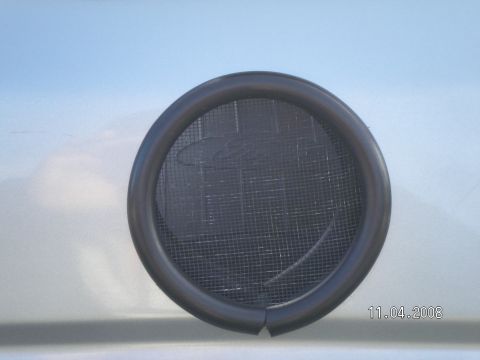 1996 Ford Bronco - Gas hose cut lengthwise to cover sharp edges while household window screen keeps debris out.