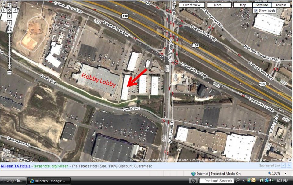 Aerial view of Hobby Lobby and surrounding businesses with roads and traffic