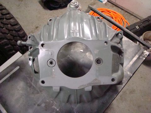 1948 Jeep Wrangler - Unidentified gray metal automotive part with a central circular opening and mounting holes.
