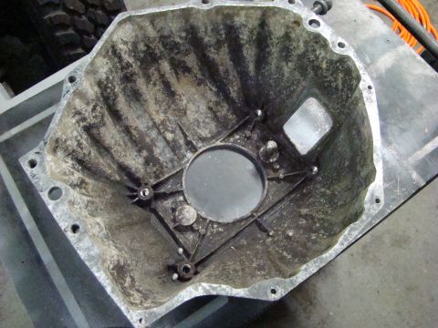1948 Jeep Wrangler - This is a close-up view of a dirty transmission bell housing, likely removed for maintenance or repair.