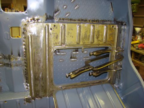 1948 Jeep Wrangler - This photo shows the interior floor of a vehicle undergoing repair work, with metal panels and clamps visible.