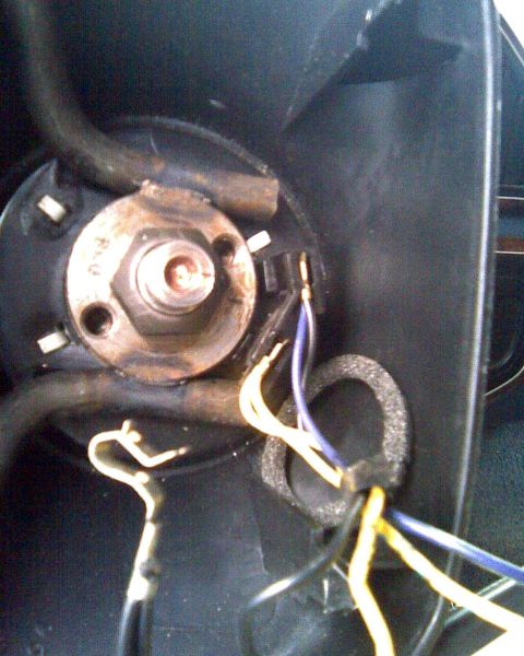 1989 Ford Bronco - Close-up view of the wiring harness and electrical connections within a vehicle's steering column.