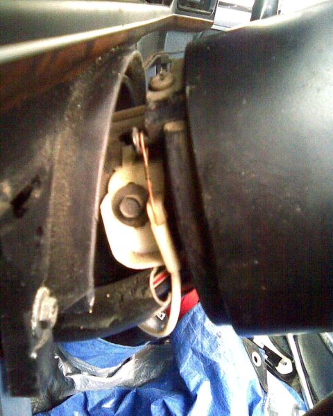 1989 Ford Bronco - Disassembled steering column components with visible wiring and housing.