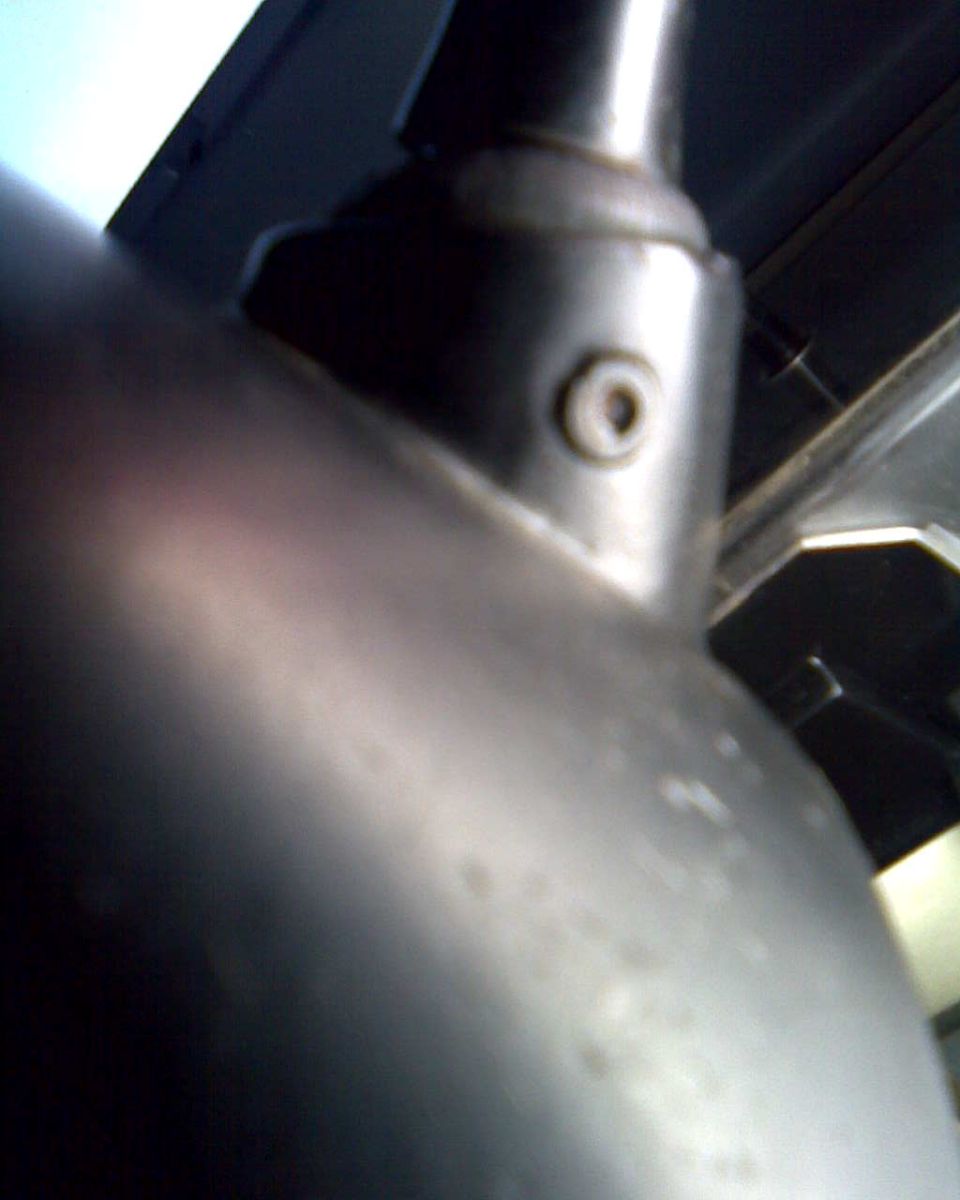 Close-up of bare steering column tube and mounting boss under the dash