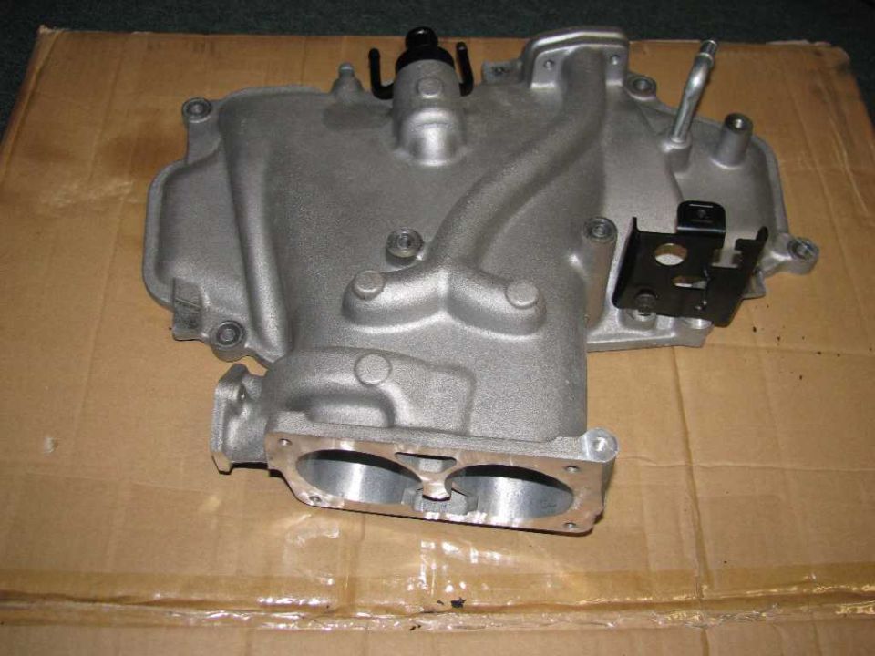 Aluminum engine intake manifold with two openings at the bottom