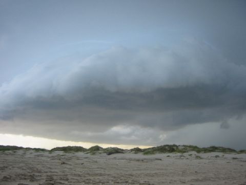 1984 Ford Bronco - Stormy sky over sand dunes.