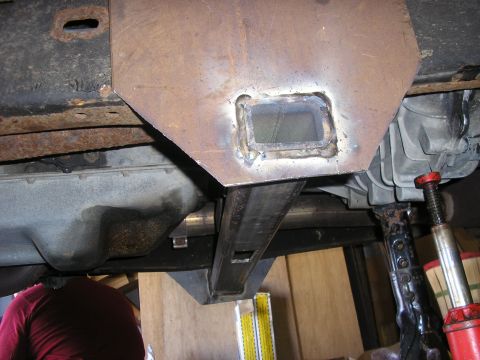 1996 Ford Bronco - Custom metalwork is visible on the underbody of a vehicle, which is being supported by a jack.