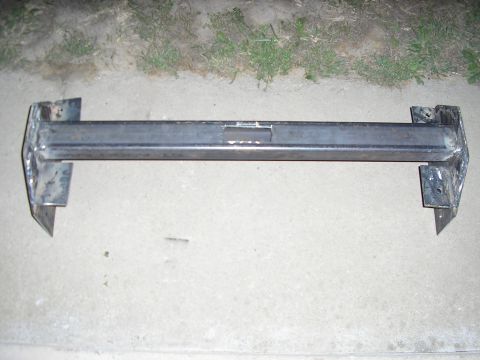 1996 Ford Bronco - A custom-fabricated steel bumper bracket is shown resting on a concrete surface.