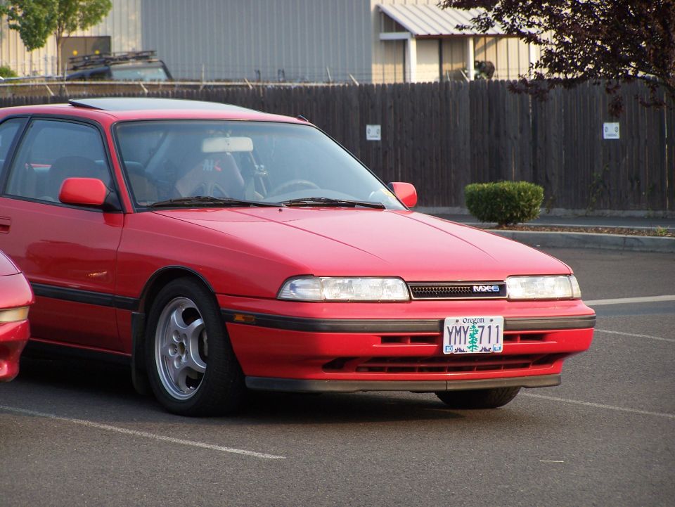 Red Mazda MX-6 coupe, front passenger side view, Oregon license plate YMY 711