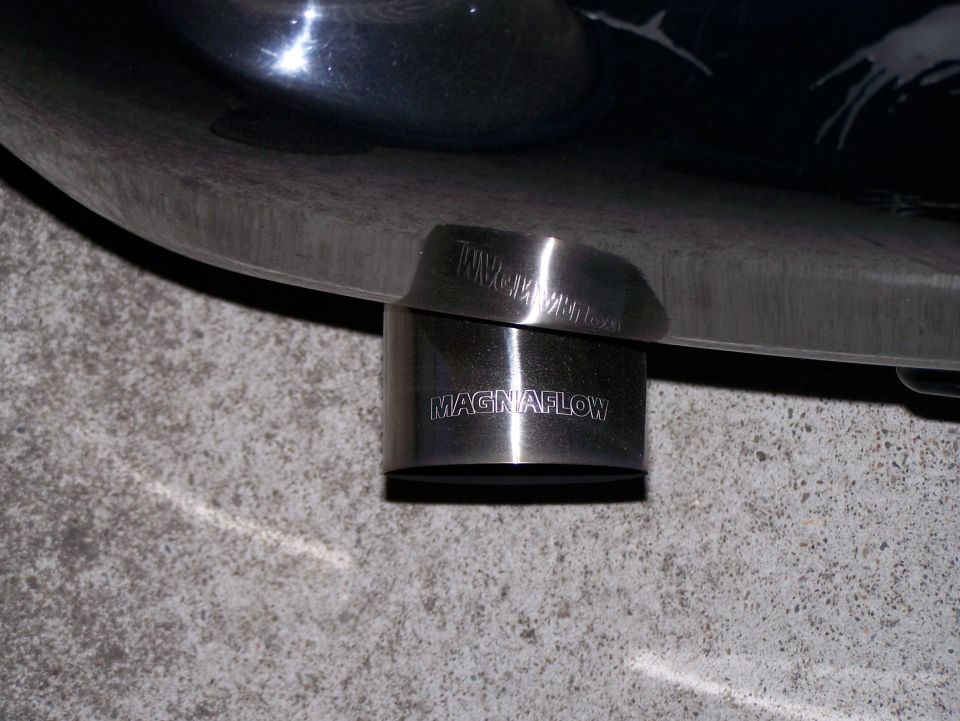 Polished metal Magnaflow exhaust tip on a vehicle.