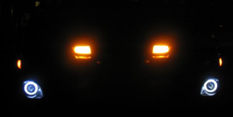 2003 Ford Focus — Hella Optilux fog lights with halos lit up.