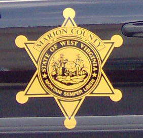 1991 Ford Crown Victoria - Close-up of a sheriff's department badge affixed to the side of a vehicle.