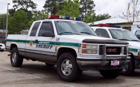1991 Ford Crown Victoria - Leon County Sheriff's GMC pickup truck, likely a 1995 model, equipped with a light bar and push bumper.