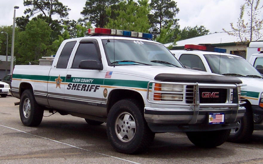 White GMC pickup truck, Leon County Sheriff, light bar, 3q-front view