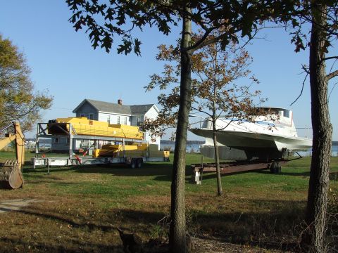 1976 Ford F-150 - Yard scene with a boat on a trailer, excavator, and a large yellow structure.