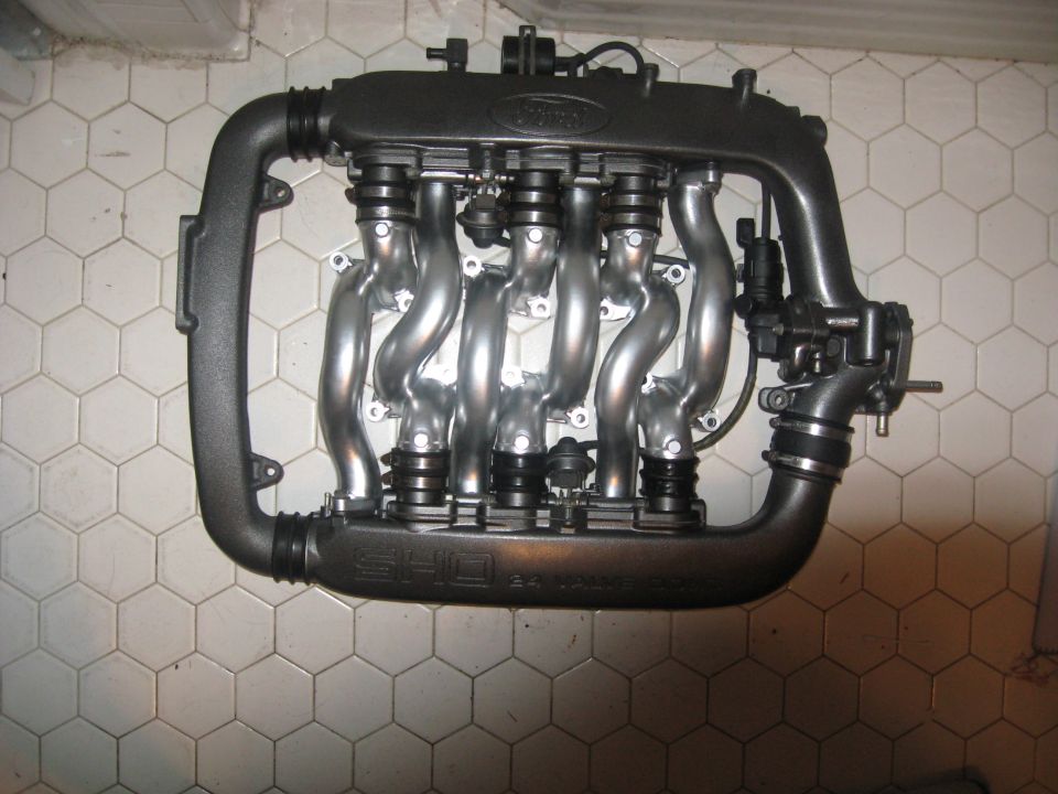 Ford SHO intake manifold with polished runners and black housing. Text on the manifold reads 'SHO'