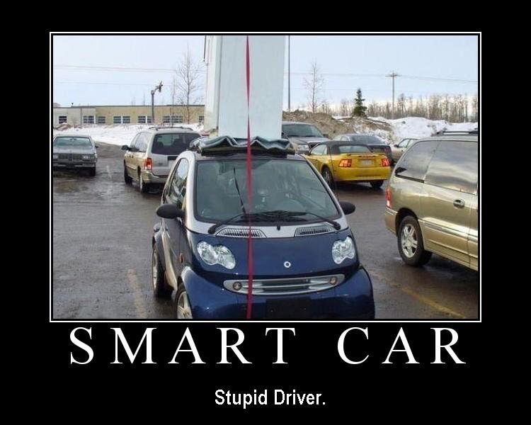 Dark blue Smart Fortwo crammed sideways in a parking lot, captioned SMART CAR
